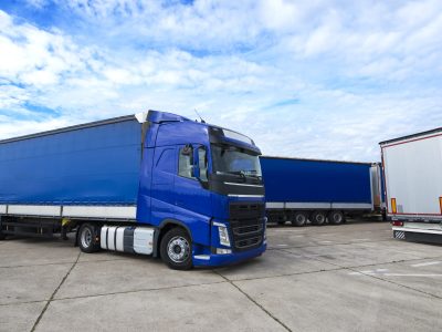 truck vehicle with trailers in background. truck vehicle with trailers in background.